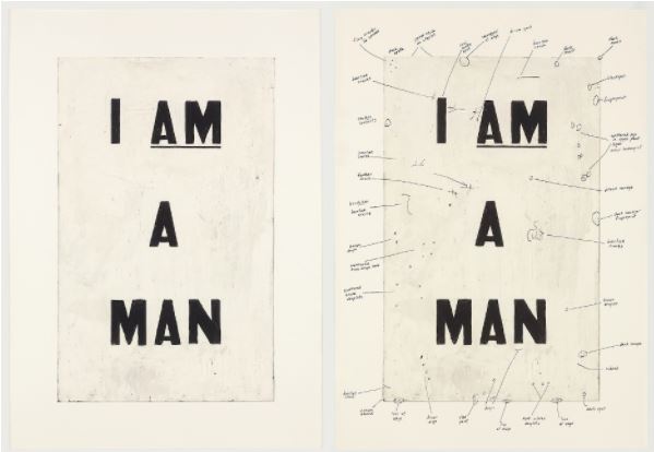 Image of two plaques that say “I AM A MAN.” The second one has scribbling on it to note revisions.